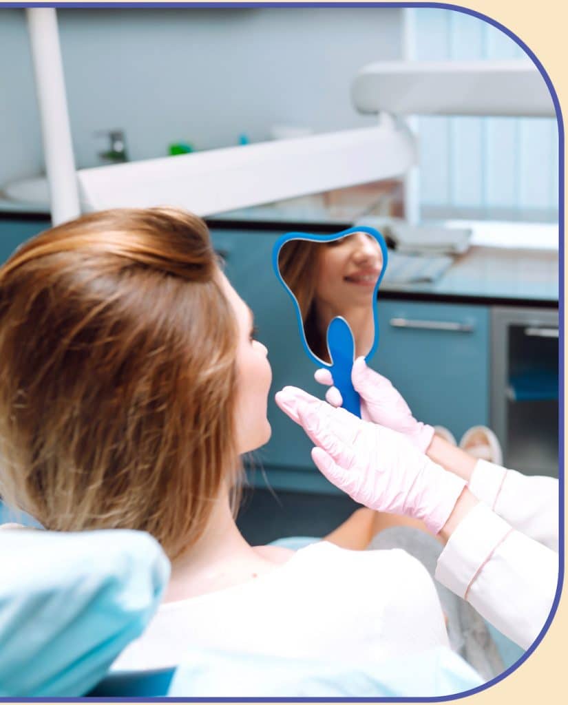 woman smiling into mirror during dental appointment at inspired smiles